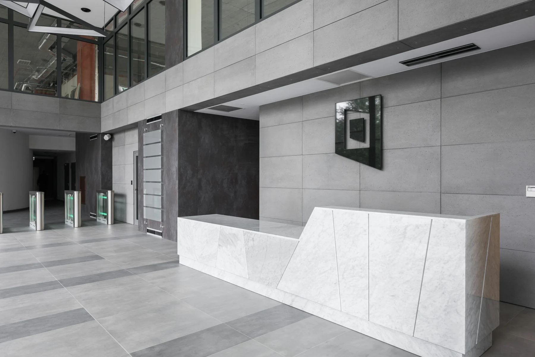 Concrete panel reception wall in a large architectural space