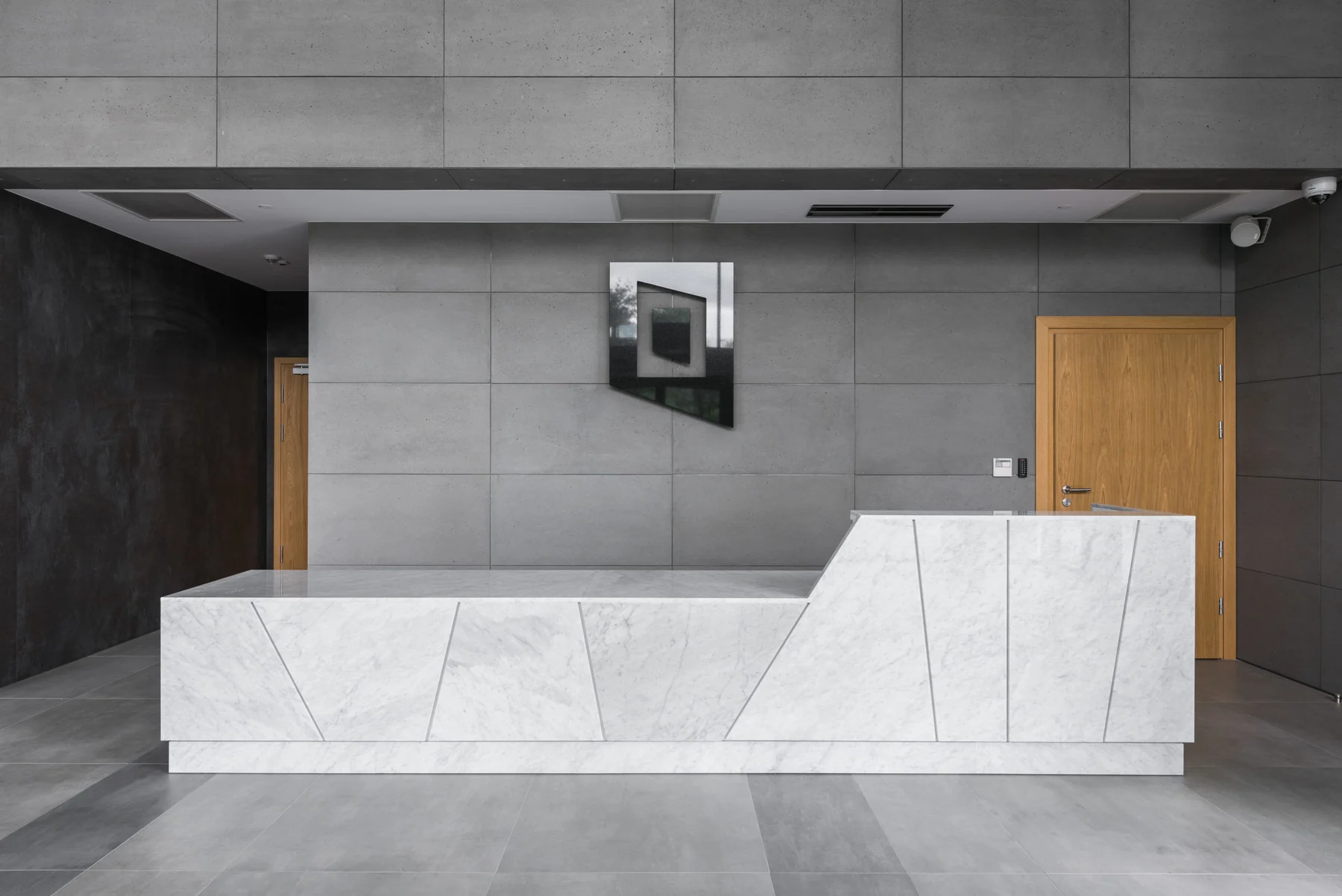 Light grey concrete panel wall in a modern reception area