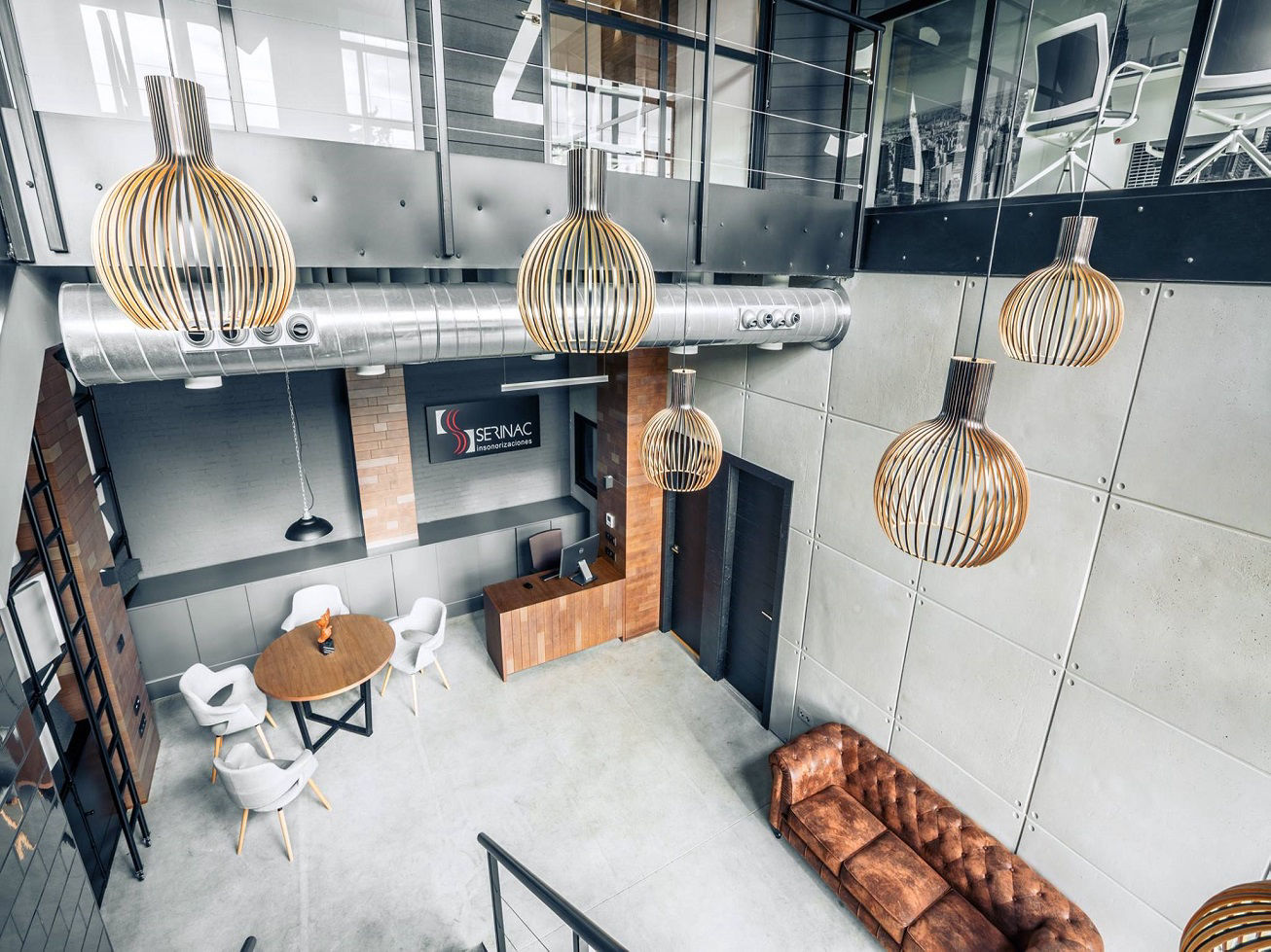 Concrete panel wall cladding in a high-ceilinged commercial space
