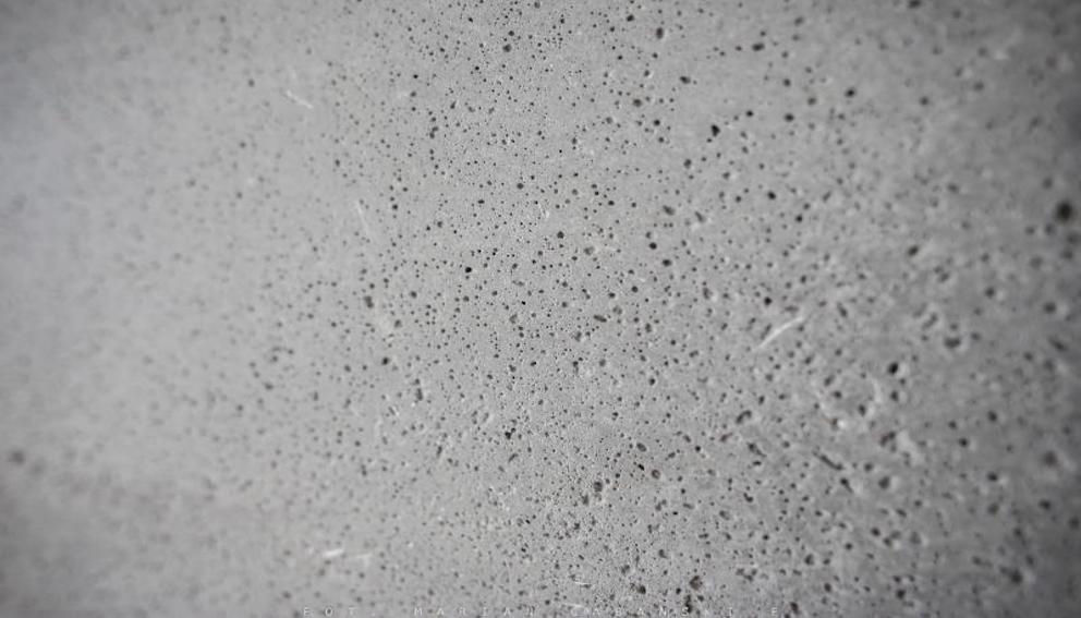 Natural pores and texture on an exposed concrete panel surface